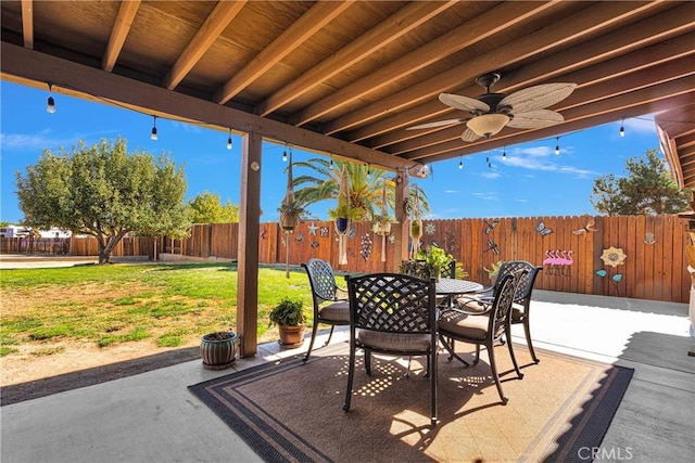 view of patio featuring a ceiling fan, outdoor dining space, and a fenced backyard