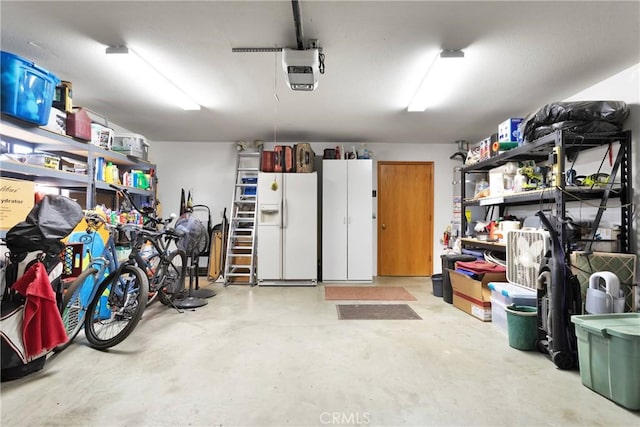 garage with white fridge with ice dispenser and a garage door opener