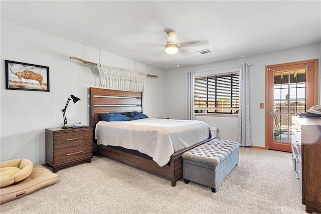 bedroom with access to exterior, light colored carpet, visible vents, a ceiling fan, and baseboards