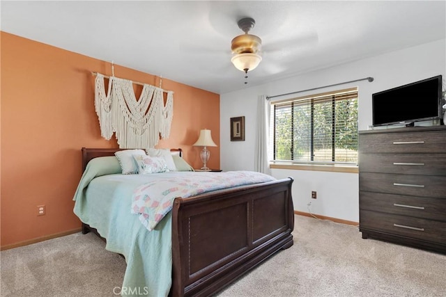 bedroom featuring baseboards, ceiling fan, and light colored carpet