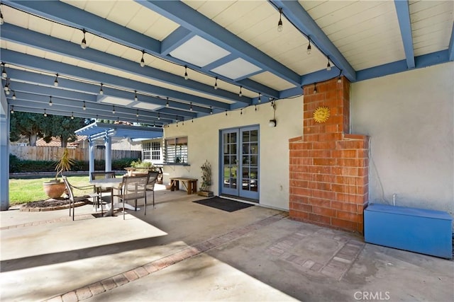 view of patio / terrace with french doors, fence, and outdoor dining area