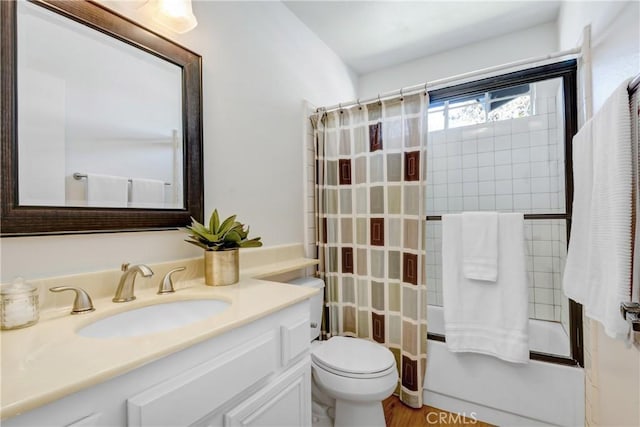 full bath featuring toilet, vanity, and shower / tub combination