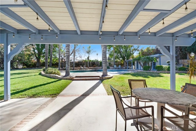 view of patio / terrace with outdoor dining space and an outdoor pool