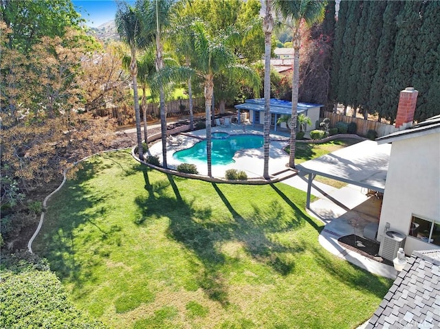 view of pool featuring a fenced backyard, a pool with connected hot tub, a lawn, and a patio