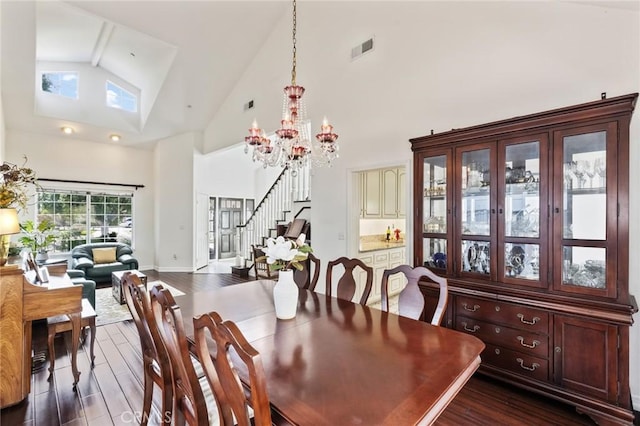13440 Pala Ave, Sylmar, CA 91342 - dining area featuring stairway, dark wood-style flooring, a chandelier, and high vaulted ceiling