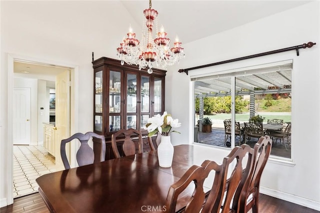 13440 Pala Ave, Sylmar, CA 91342 - dining room featuring a chandelier, wood finished floors, baseboards, and a high ceiling