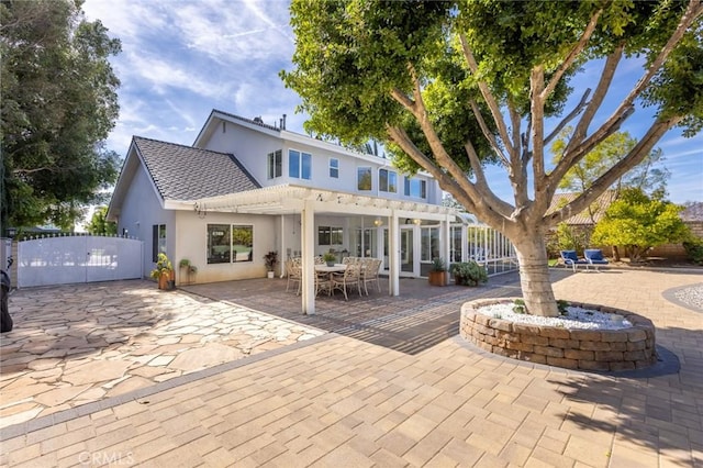 13440 Pala Ave, Sylmar, CA 91342 - rear view of house with stucco siding, a patio, a pergola, and a gate