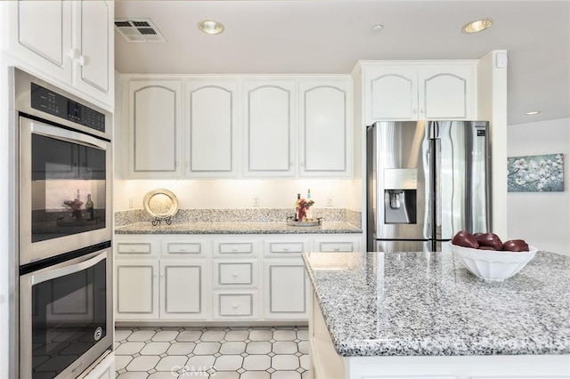 13440 Pala Ave, Sylmar, CA 91342 - kitchen with appliances with stainless steel finishes, white cabinetry, light stone countertops, and recessed lighting