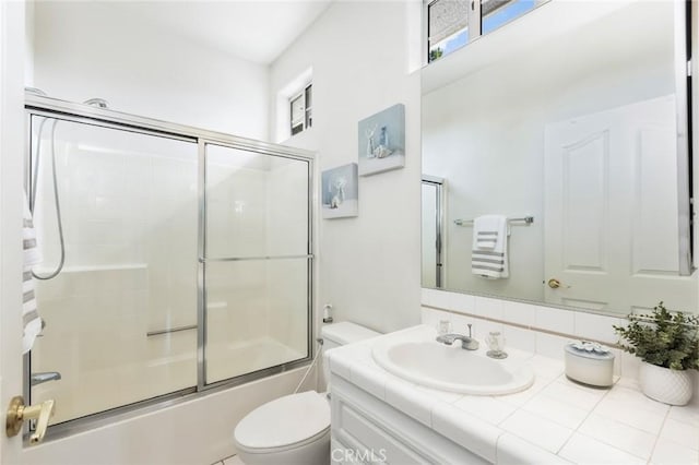 13440 Pala Ave, Sylmar, CA 91342 - bathroom with vanity, healthy amount of natural light, toilet, and shower / bath combination with glass door
