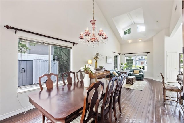 13440 Pala Ave, Sylmar, CA 91342 - dining space with dark wood-type flooring, a chandelier, high vaulted ceiling, and baseboards