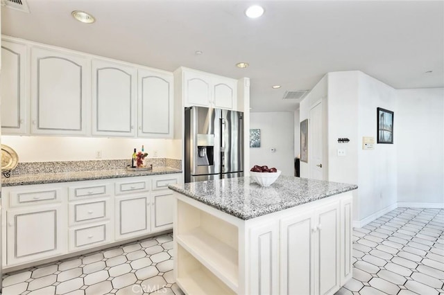 13440 Pala Ave, Sylmar, CA 91342 - kitchen with stainless steel refrigerator with ice dispenser, light flooring, white cabinetry, light stone counters, and recessed lighting