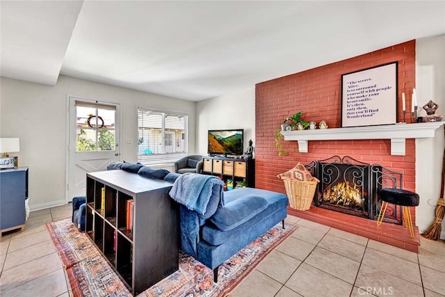 living area featuring a brick fireplace, tile patterned flooring, and baseboards