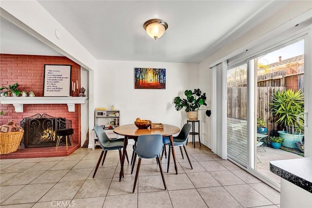 tiled dining space featuring a fireplace