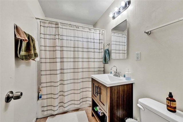 full bath featuring toilet, shower / tub combo, and vanity