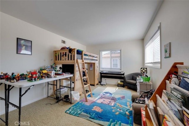 carpeted bedroom featuring visible vents