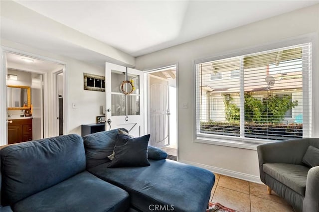 living area with light tile patterned floors and baseboards