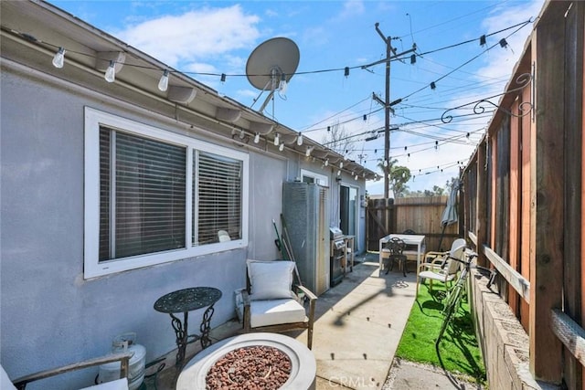 view of patio / terrace with fence and a grill