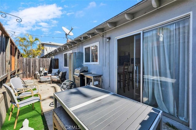 view of patio featuring a fenced backyard, grilling area, and outdoor dining space