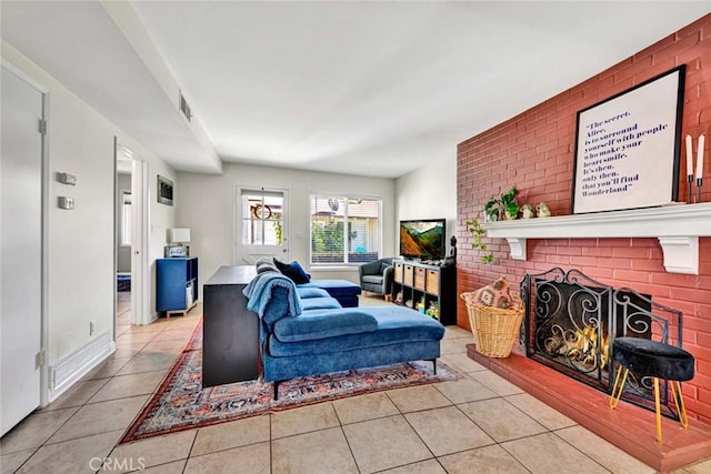 living area with a fireplace and light tile patterned floors