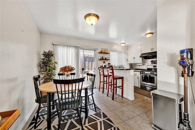 dining room with light tile patterned floors and baseboards