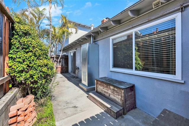 view of home's exterior featuring a patio, fence, and stucco siding