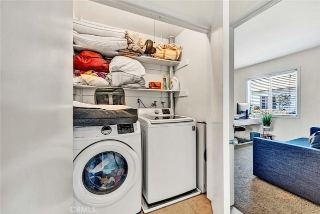 laundry room featuring laundry area, light tile patterned floors, and washer and dryer