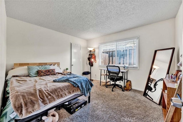 bedroom featuring carpet floors, baseboards, and a textured ceiling