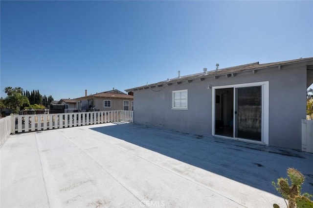 rear view of property with a patio and stucco siding