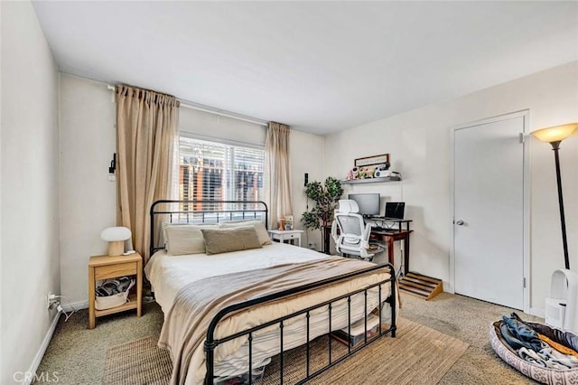 bedroom with carpet flooring and baseboards