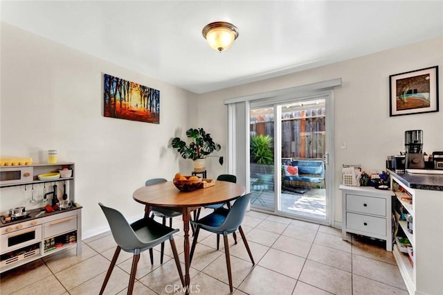 dining room featuring light tile patterned flooring and baseboards