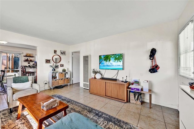 living room featuring baseboards and light tile patterned floors