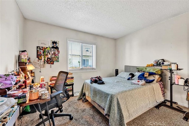 carpeted bedroom featuring baseboards and a textured ceiling