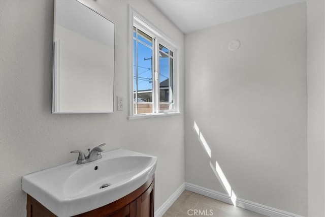 bathroom with vanity and baseboards