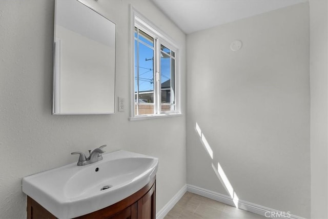bathroom with baseboards and vanity
