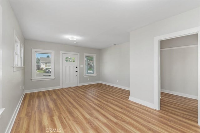 entryway with light wood finished floors and baseboards