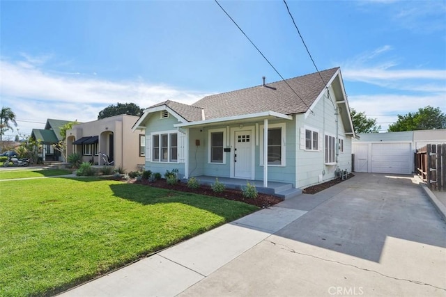 bungalow with a garage, a front lawn, roof with shingles, and covered porch