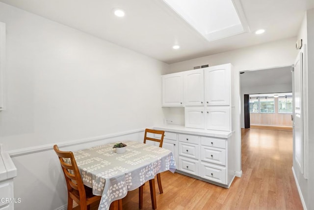 dining area with baseboards, light wood finished floors, visible vents, and recessed lighting