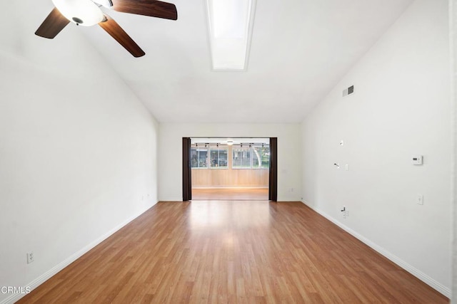 interior space with light wood finished floors, visible vents, a ceiling fan, high vaulted ceiling, and baseboards