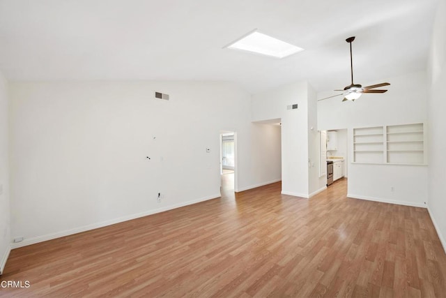 unfurnished living room featuring a skylight, baseboards, visible vents, ceiling fan, and light wood-style floors