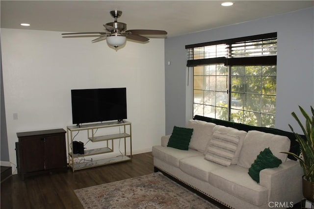 living area featuring baseboards, dark wood-type flooring, a ceiling fan, and recessed lighting