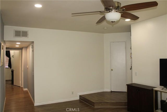 interior space featuring recessed lighting, dark wood finished floors, visible vents, and baseboards