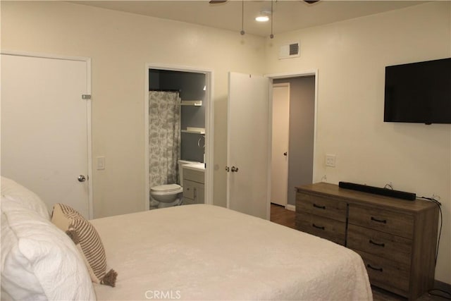 bedroom featuring visible vents and ensuite bath