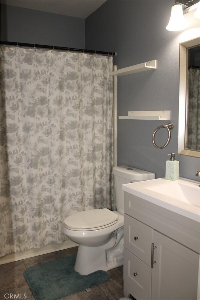 full bath with toilet, a shower with shower curtain, tile patterned flooring, and vanity