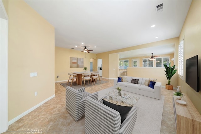 living area with light tile patterned floors, ceiling fan, recessed lighting, visible vents, and baseboards