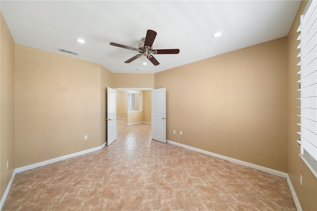 empty room featuring a ceiling fan, recessed lighting, visible vents, and baseboards