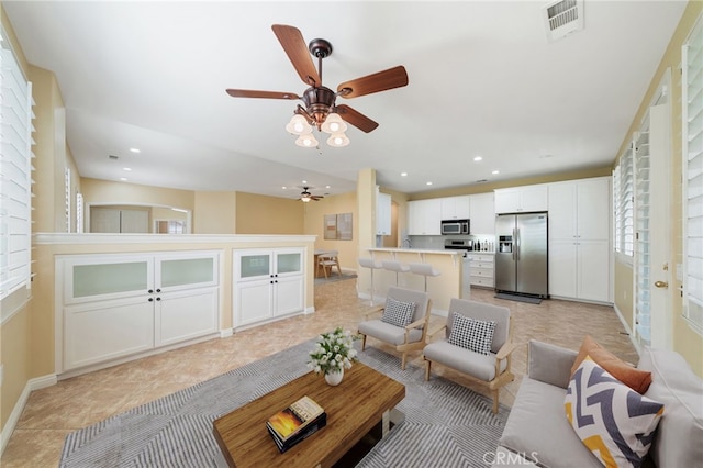 living room featuring recessed lighting, visible vents, baseboards, and light tile patterned floors