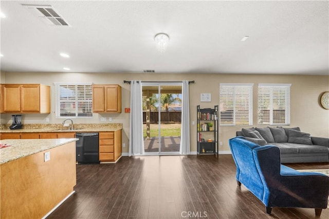 kitchen featuring a sink, visible vents, open floor plan, dishwasher, and dark wood finished floors