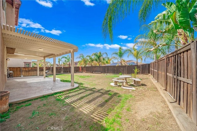 view of yard with a patio, a fenced backyard, and a pergola