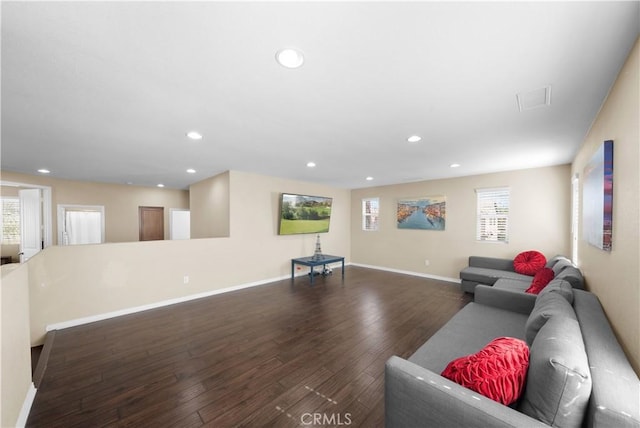 living area with baseboards, dark wood finished floors, and recessed lighting