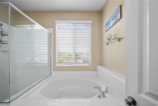 full bathroom with a wealth of natural light, a shower stall, and a bath